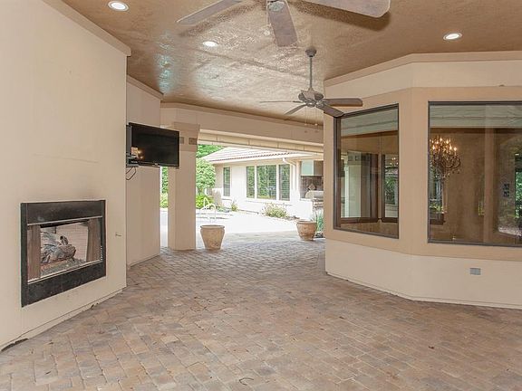 Enter through huge courtyard with fireplace, tv, pool. Perfect for watching any sports.
