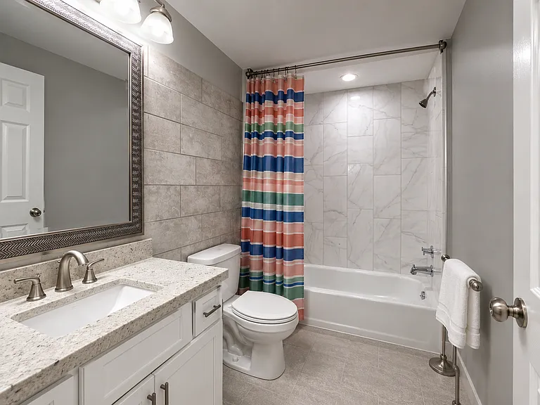 Full bathroom with a tub and shower. Simple comfort for your daily routine.
