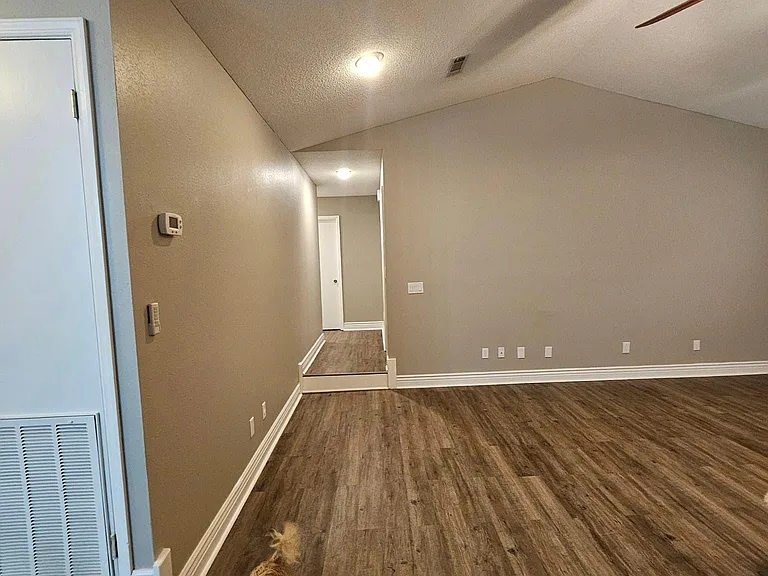 Off to the left of the living room.... the hallway accesses the 3 bedrooms and spare bathroom.