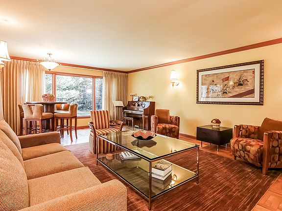 Spacious living room with large picture window facing the backyard.