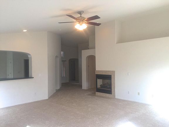 Giant bright living room with dramatic vaulted ceiling and p