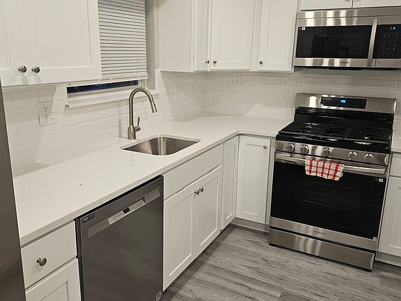 Kitchen w/ Stainless Steel Appliances, Gas Stove, Refrigerator/Freezer with Ice and Water Dispenser, and a pantry.