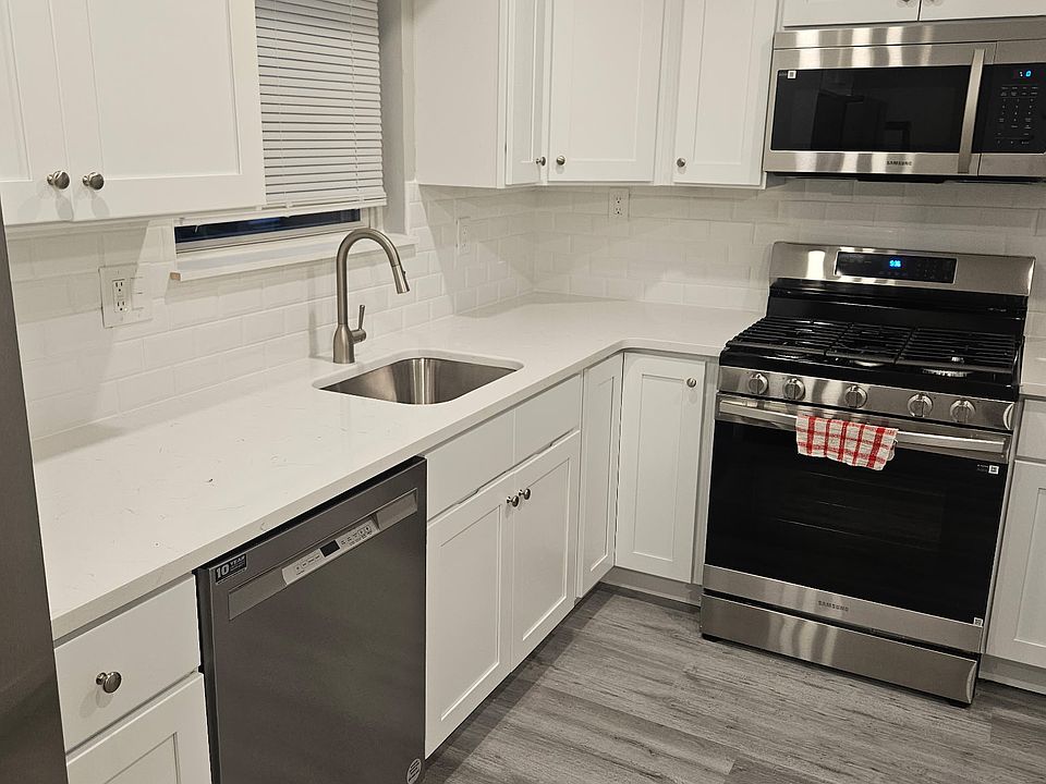 Kitchen w/ Stainless Steel Appliances, Gas Stove, Refrigerator/Freezer with Ice and Water Dispenser, and a pantry.