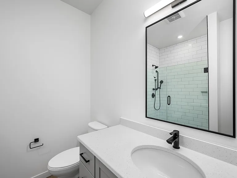 Modern bathroom with sleek fixtures, a luminous countertop, and a spacious glass shower. Modern bathroom with sleek fixtures, a luminous countertop, and a spacious glass shower.