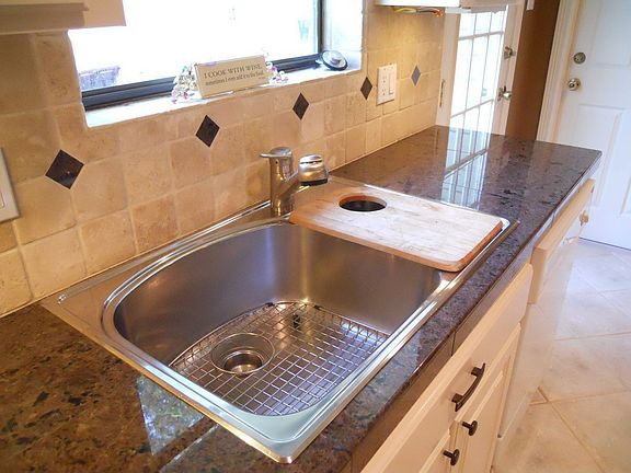 Labrador antique granite and tumbled marble back splash