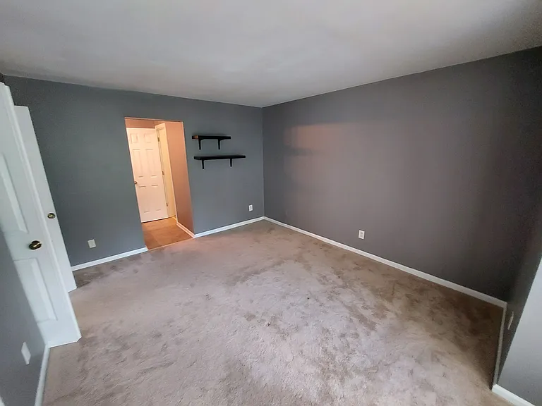 Primary bedroom is quiet and on the courtyard. Walk-in closet, shelving, access to primary vanity, and full surround tub and shower.