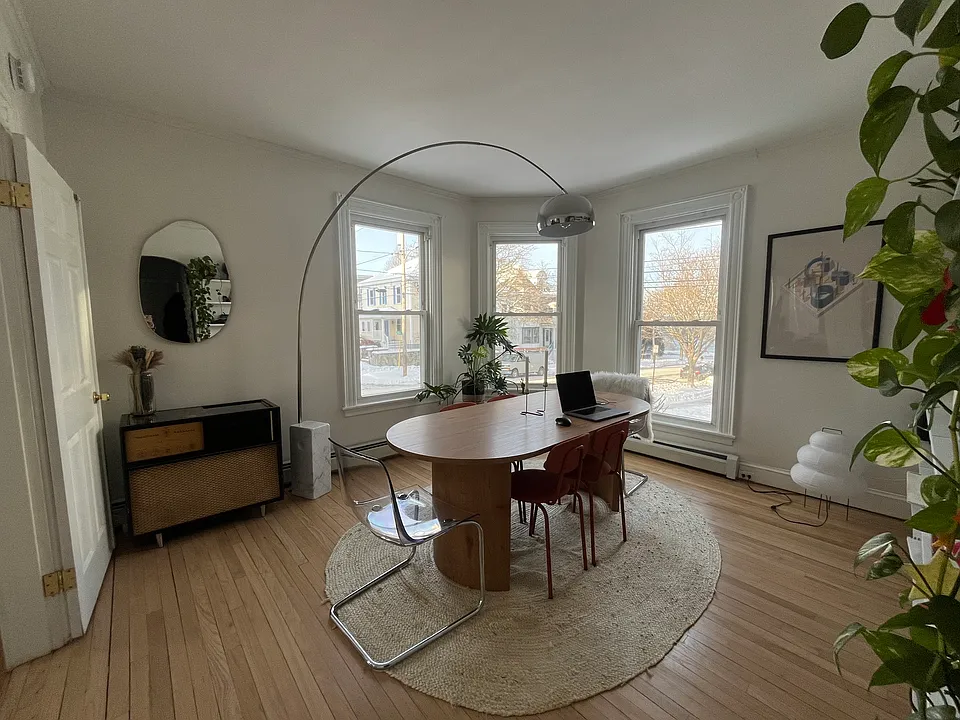 Living/dining room - giant windows and tons of natural light. Restored 1910 floors.