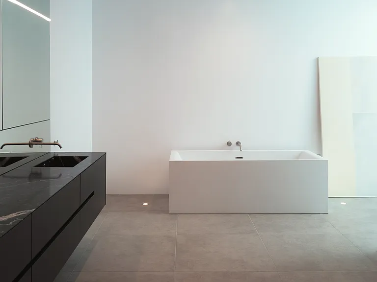 Spa-Like Bathroom with Therapeutic Tub _ A haven of tranquility, this en-suite bathroom features a contemporary therapeutic soaking tub, glass-enclosures for shower and toilet room, and sleek fixtures, creating the ultimate spa experience at home.