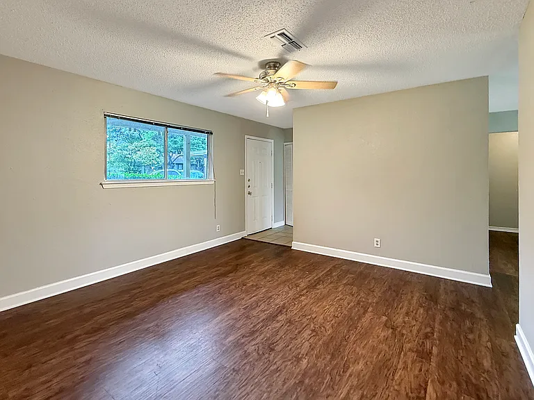 Spacious Living Room (13'x13'). View towards front door on left, dining room on right.