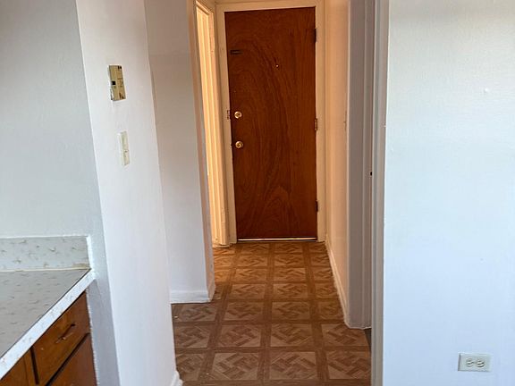 Hallway. Bathroom on the right. Bedroom and living room on the left.
