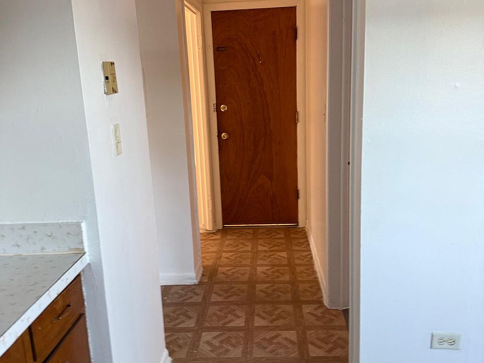 Hallway. Bathroom on the right. Bedroom and living room on the left.