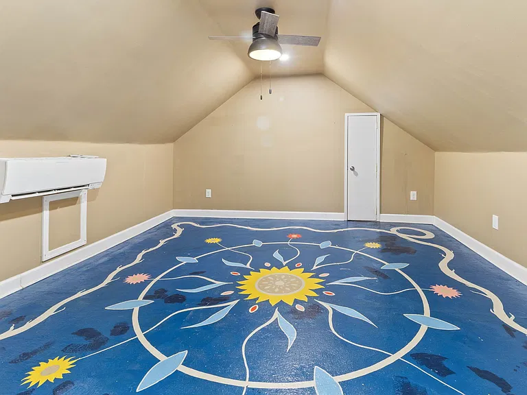 Upstairs Bedroom with Floor Mural Unique upstairs bedroom with a custom floor mural by a local artist perfect as a creative retreat or studio workspace.