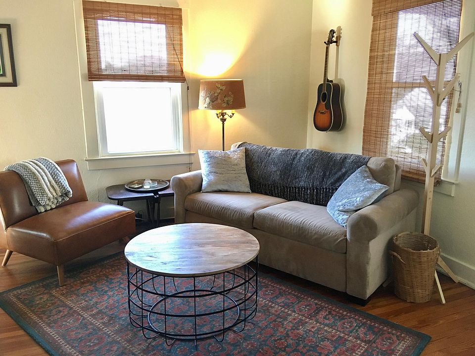 The sunlit living room with super-comfy queen-sized pull-out sofa