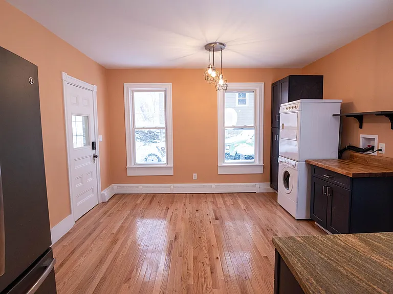 dining area of kitchen featuring pantry, washer and dryer, folding area and door to back porch