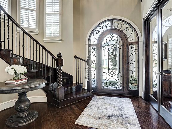 Stunning custom wrought iron door and two story entry