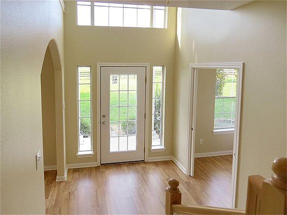 Wide foyer with faux transom window and high ceiling!