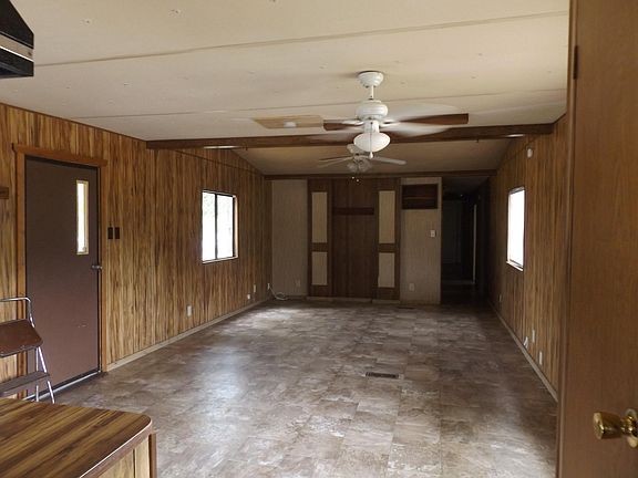 Open space dining and living area with vaulted ceiling. 