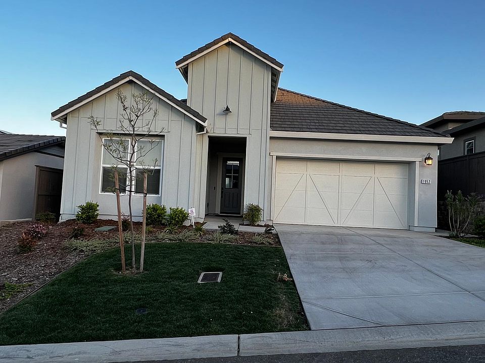 Front entry of the home. Two car garage and two car driveway. Serrano HOA maintains front landscaping.