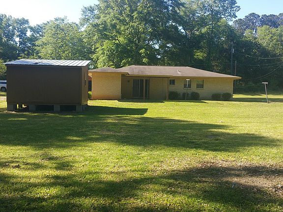 Back of house with shed, carport, back porch and large yard