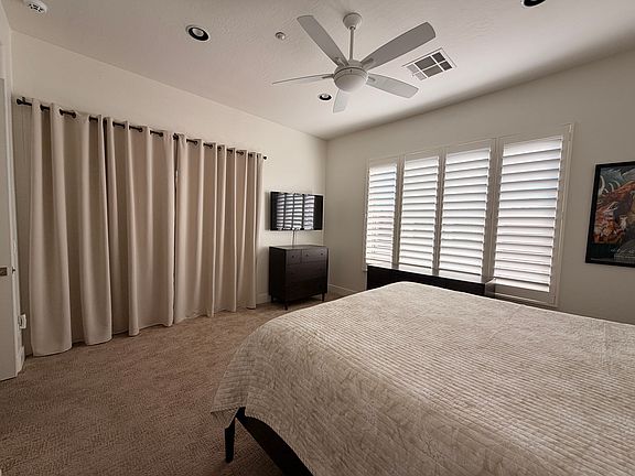 Master bedroom with sliding glass door leading to back patio.
