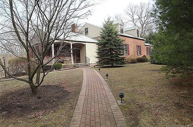Loads of curb appeal with charming brick walkways that lead you to the covered front porch and entrance