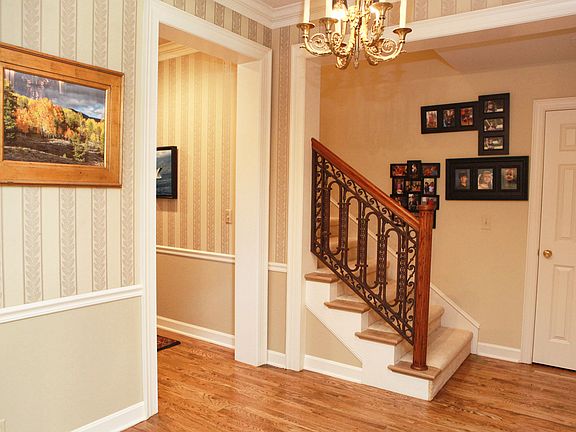 An oversized entry foyer allows for ample space to welcome friends and family. Notice the great detail on the banister.