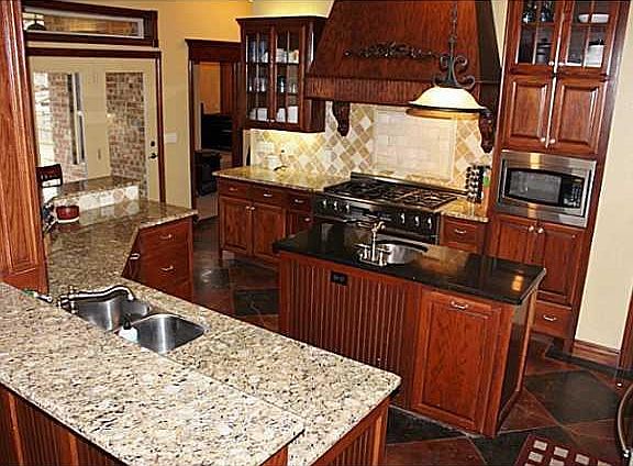 Kitchen. Gourmet kitchen with granite, custom cabinets, commercial double over gas range, island with prep sink, huge pantry and desk area and breakfast bar.