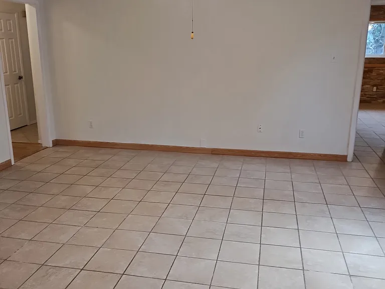 From Kitchen looking into Den with Entryway on left and Master on right.