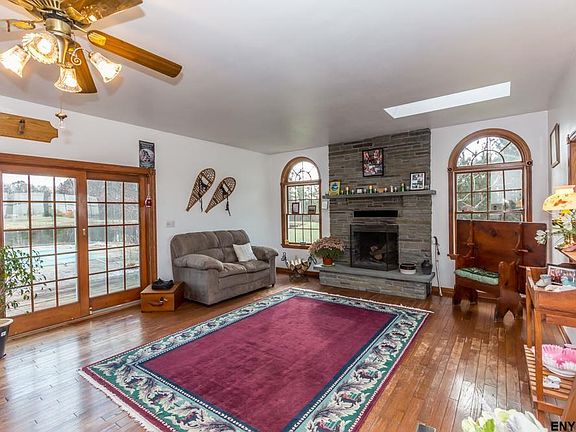 Double doors to deck, in-ground pool and sun room.