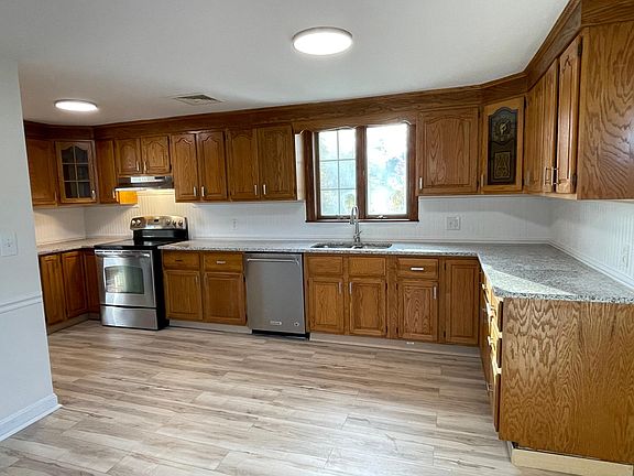Brand-new granite countertops, sink, faucet, and flooring as well as stainless appliances anchor this huge, inviting Kitchen