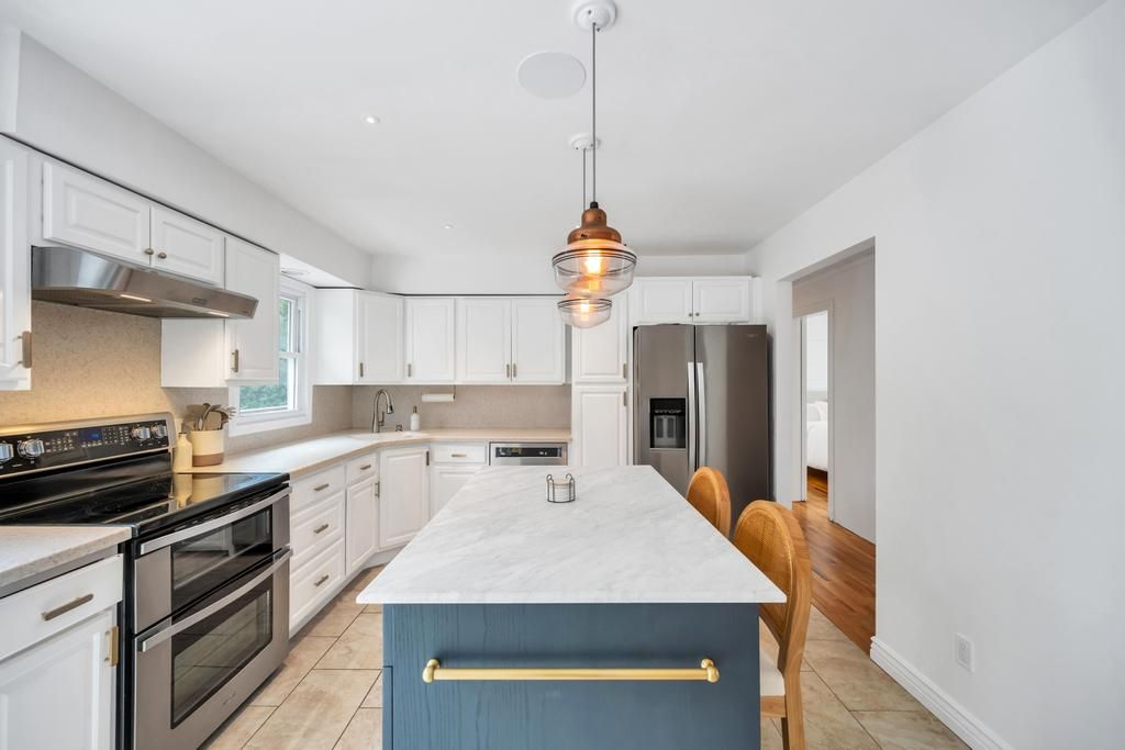  Spacious eat in kitchen with center island, stainless steel appliances.