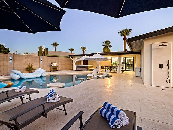 4 Chaise Lounge Chairs and Oversized Umbrellas