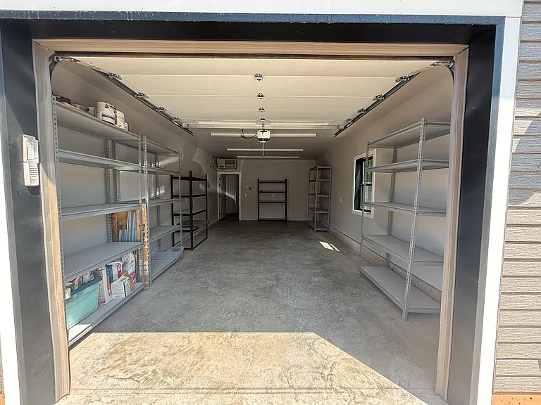oversized garage with storage shelving