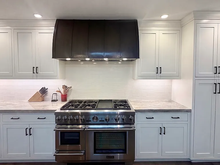 6 burner Thermador range with griddle, oven, steam oven, and venting hood