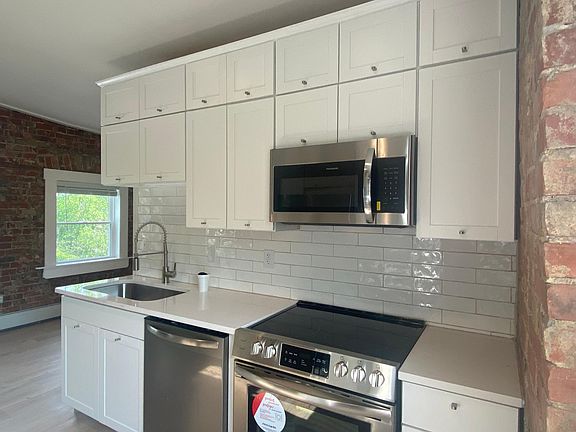 Both sides of kitchen have subway tile backsplash