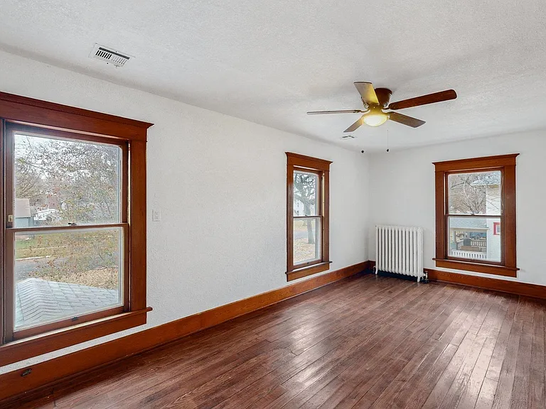 Large second floor bedroom with original wood work and hard wood floors