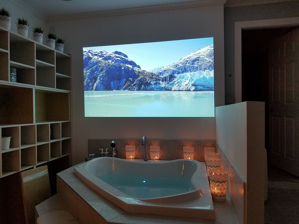 Full soaker bath tub with live art projection on the back wall. Cubby with lots of storage.