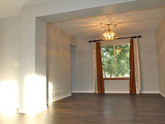 Dining room measures 10'4" by 10'11" and overlooks the back yard