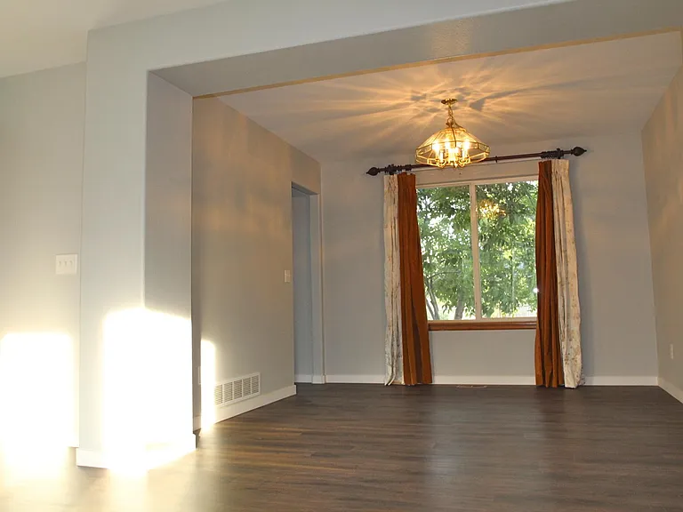 Dining room measures 10'4" by 10'11" and overlooks the back yard