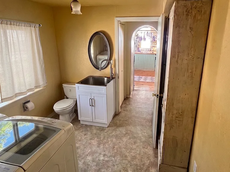 Convenient lower-level laundry room and half bath right off the kitchen_complete with extra storage for all the essentials.