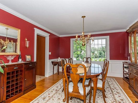 Dining room features hardwood floors, chair rail, picture frame molding and crown molding.