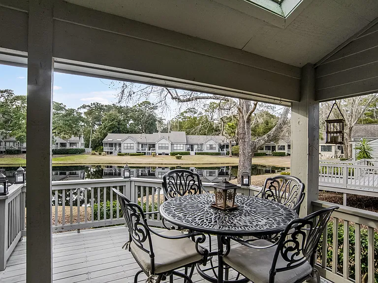 Enjoy al fresco dining on the private deck with lakefront views! This peaceful outdoor space features a grill and seating for the perfect Lowcountry evening.