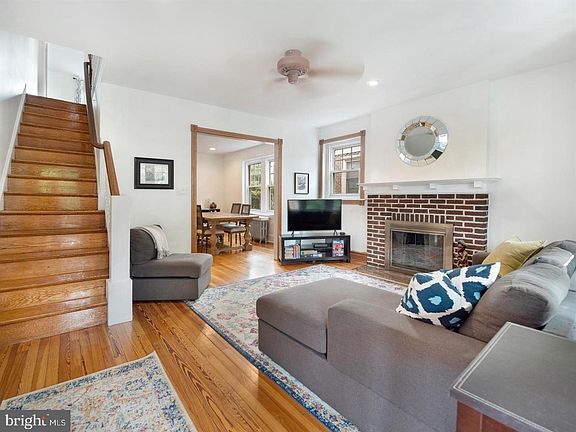 Living room with working fireplace and beautiful hardwood flooring!