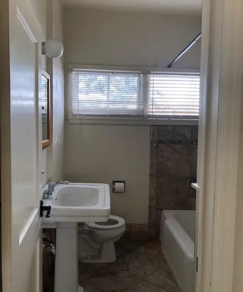 Bathroom has ceramic tile surround in shower and on the floor