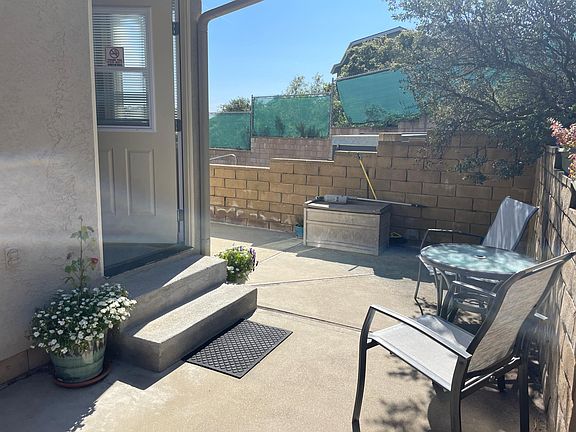 Front door to unit with keyless entry. Ground level unit (2 steps into front door). Small exterior table and chairs. Nearby hot tub available for use.