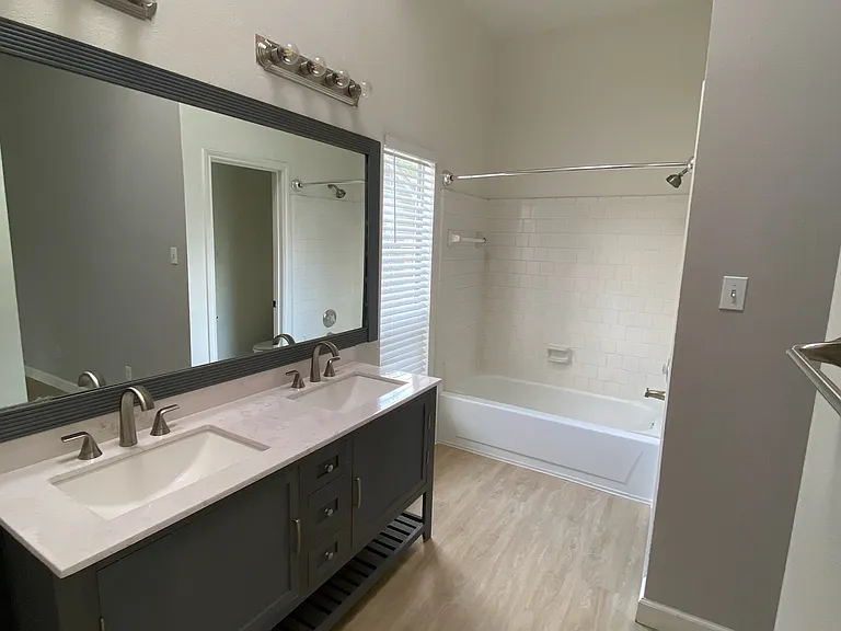 Connected primary bathroom with double vanity