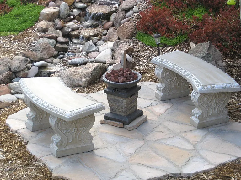 Patio and seating area at foot of waterfall
