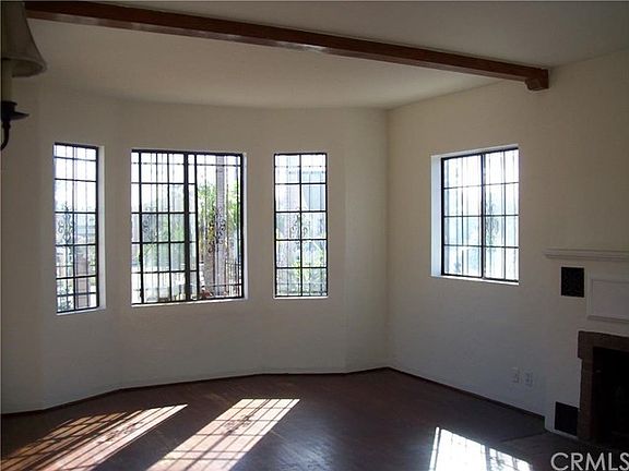 Living room with beams, fireplace and wood floors