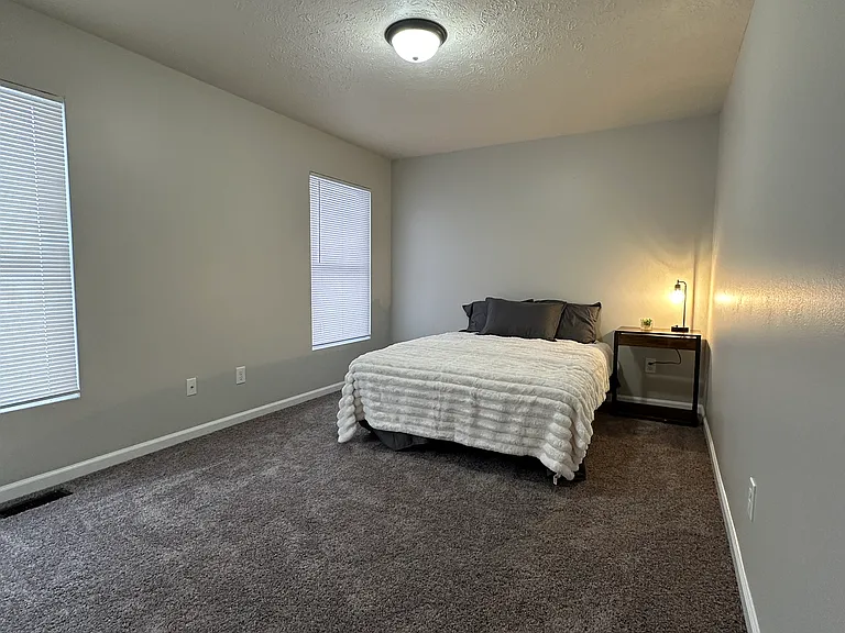 (3-Bedroom 1.5 Bath Unit ) Front Bedroom - Freshly painted and updated carpet.