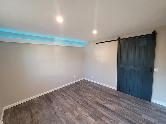 FAMILY ROOM - ACCENT LIGHTING, LED CAN LIGHTING, BARN DOOR, LUXURY VINYL PLANK FLOORING, NEUTRAL COLORS